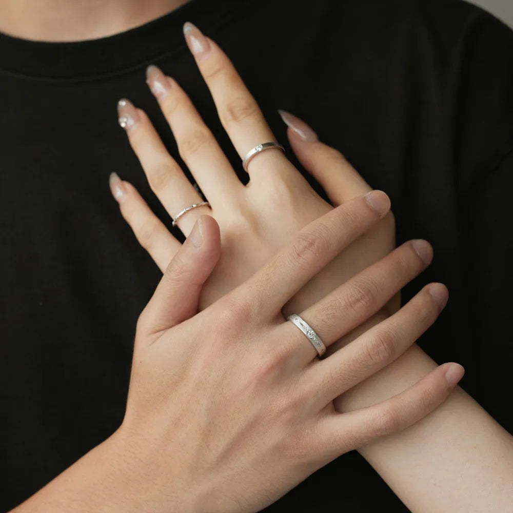 Sterling silver couple ring with geometric round diamond inlay in white gold finish on neutral background