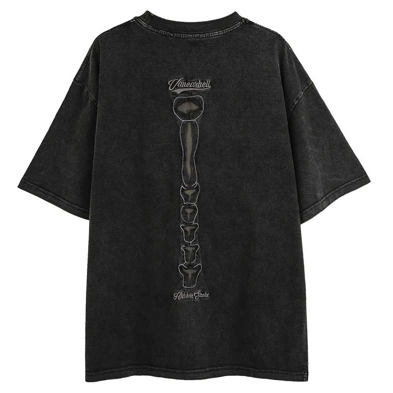 Man wearing a loose-fit black cotton pullover with a skull and letter graphic print on the front.