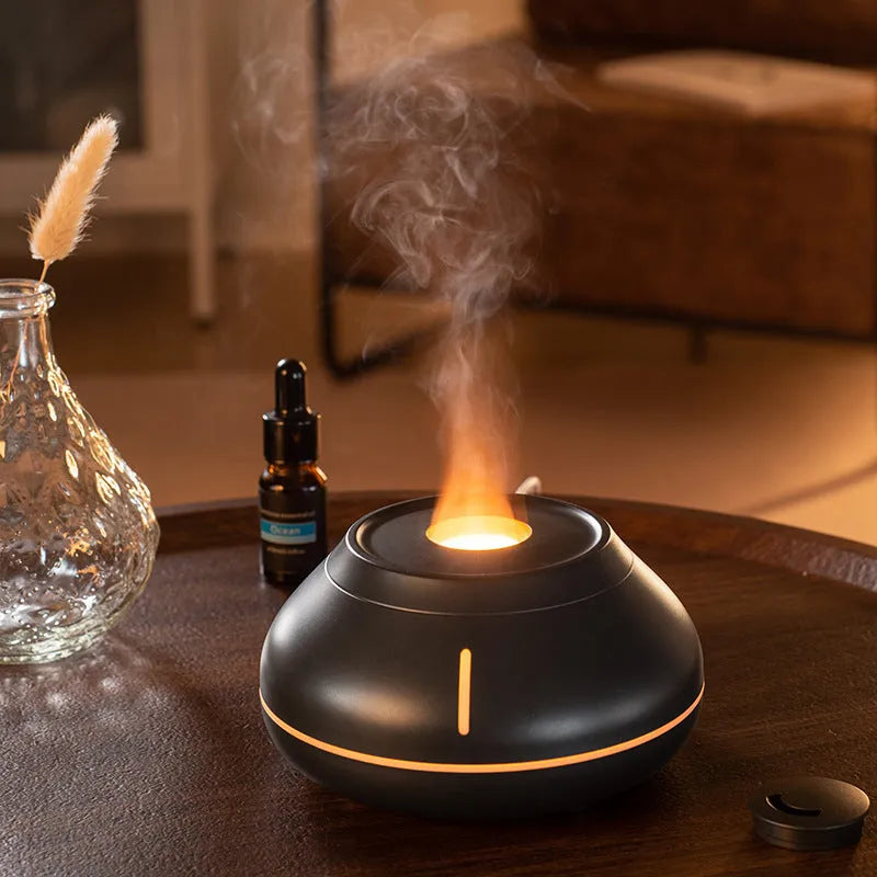 White round desktop aroma diffuser humidifier with colourful LED flame effect light on.