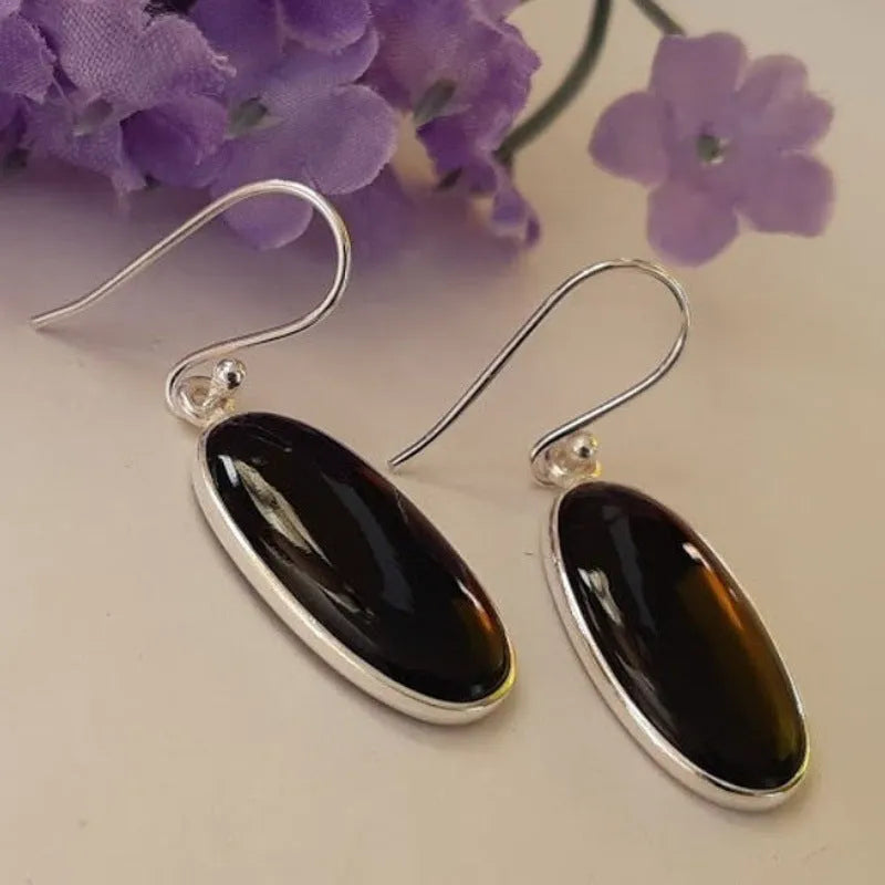 A pair of women's geometric earrings with a black agate oval pendant on alloy settings.