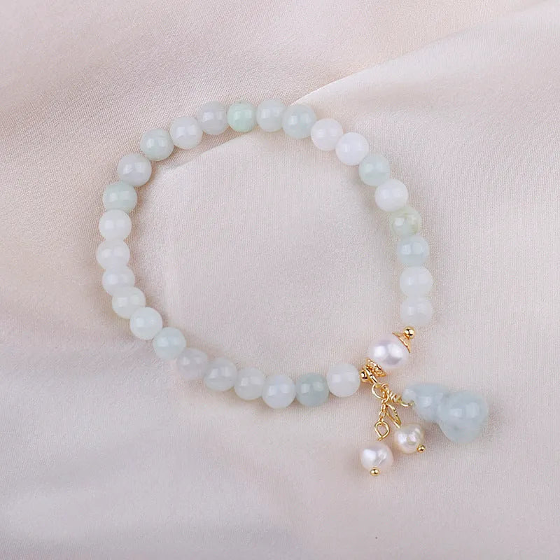 Chinese style women's jade bracelet with traditional gourd design featuring emerald jade insets and pearl elements