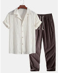 Slim-fit men's camouflage print shirt and trousers casual suit set on a hanger.