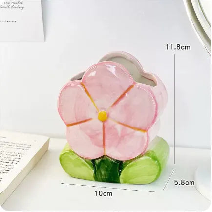 Ceramic pen holder storage box with floral pattern decoration on desktop