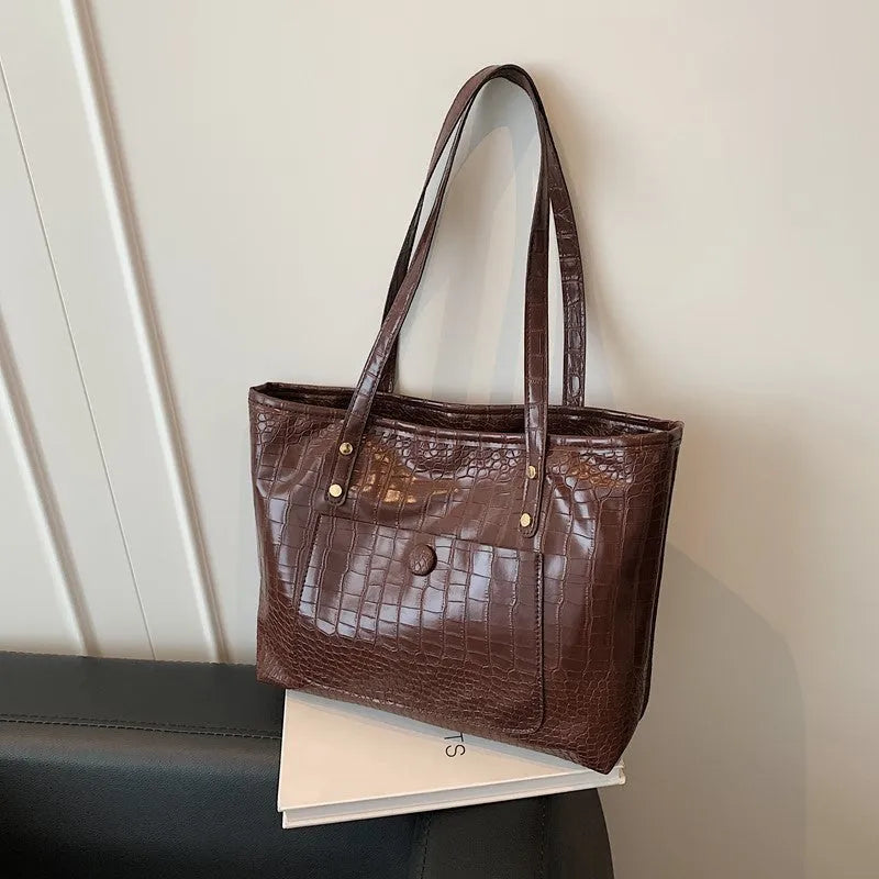 Retro large capacity single-shoulder handbag in brown, soft PU material with stitching detail, horizontal square shape.