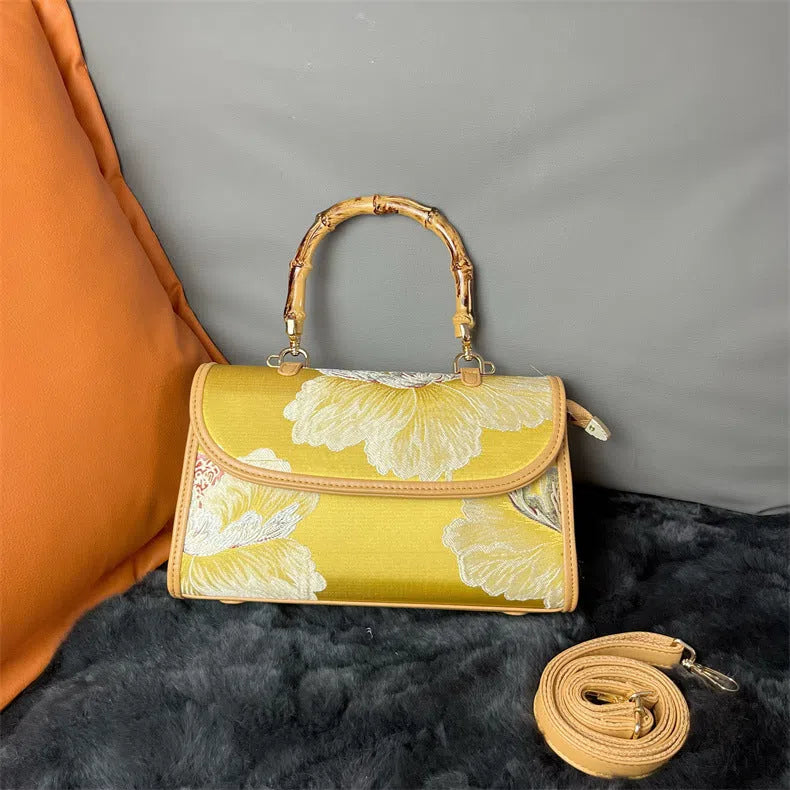 Vintage Chinese-style Xiangyun silk handbag with retro patterns, horizontal rectangular shape and single strap.