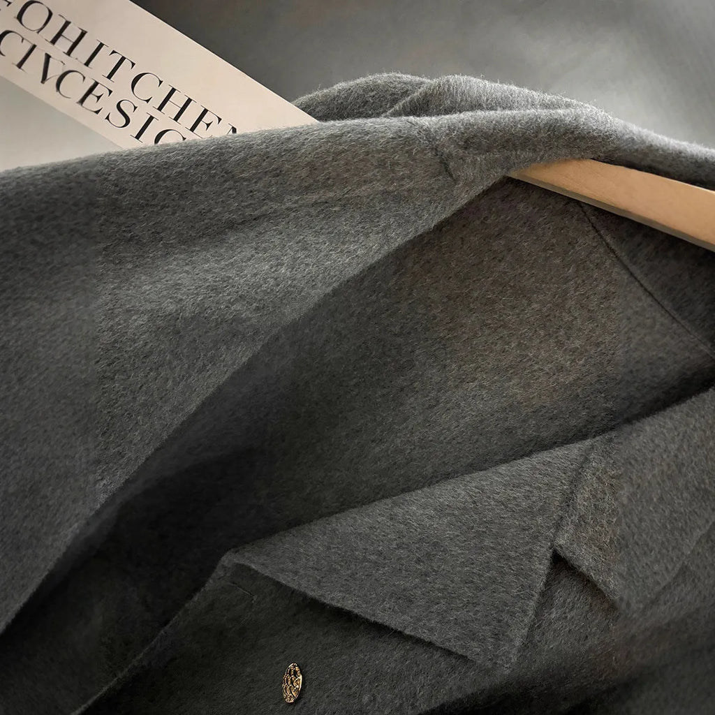Women's solid colour polyester woolen coat in black with conventional sleeves, front view
