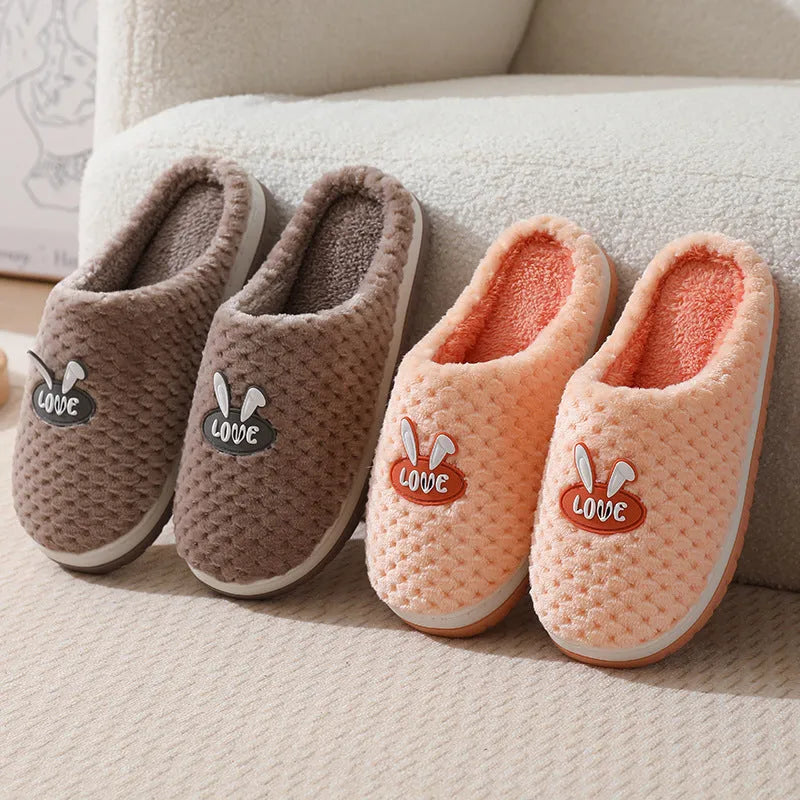 Women's rabbit plaid design winter slippers with artificial fur upper and thick rubber sole.