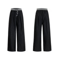Straight-leg high-waisted trousers in grey fabric with button detail on the leg.