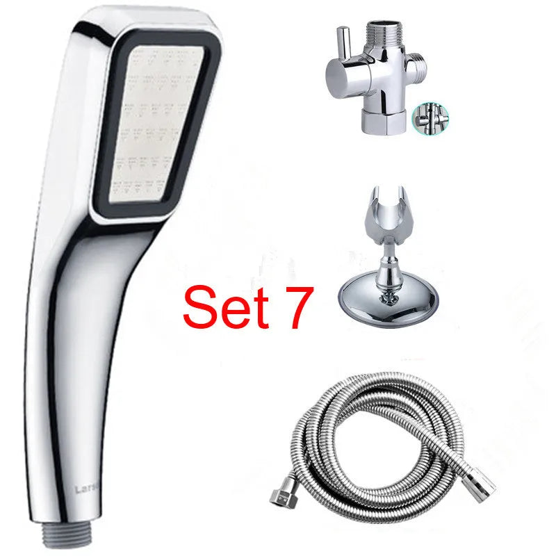 Orange hand-held rain shower with hose and wall bracket, showing adjustable spray dial.