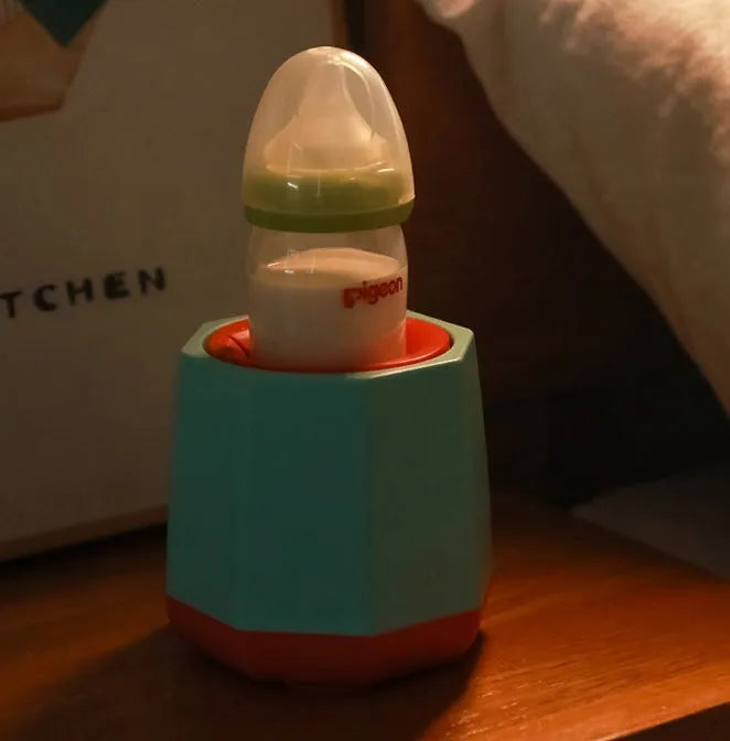 White baby electric milk shaker with silicone slot holding a baby bottle on a table, 110x110x110mm size