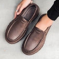Men's black mid-top slip-on work shoes with platform sole, artificial leather upper, and round toe