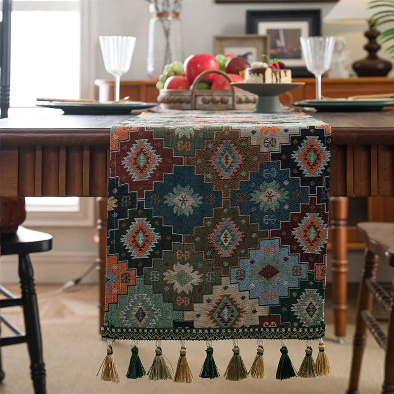 Dark blue striped jacquard table runner with tassel ends on a wooden dining table