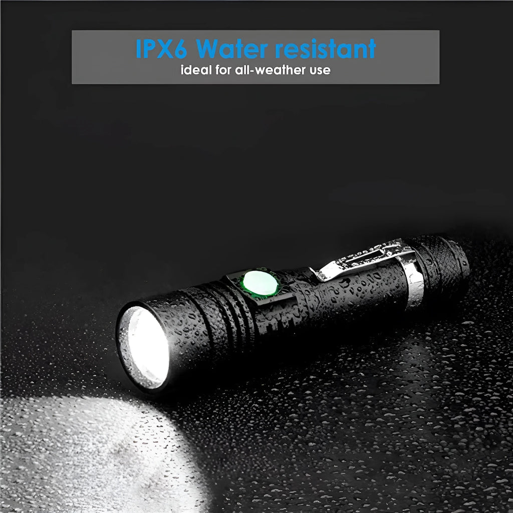 Black telescopic zoom USB rechargeable T6 LED flashlight on outdoor background
