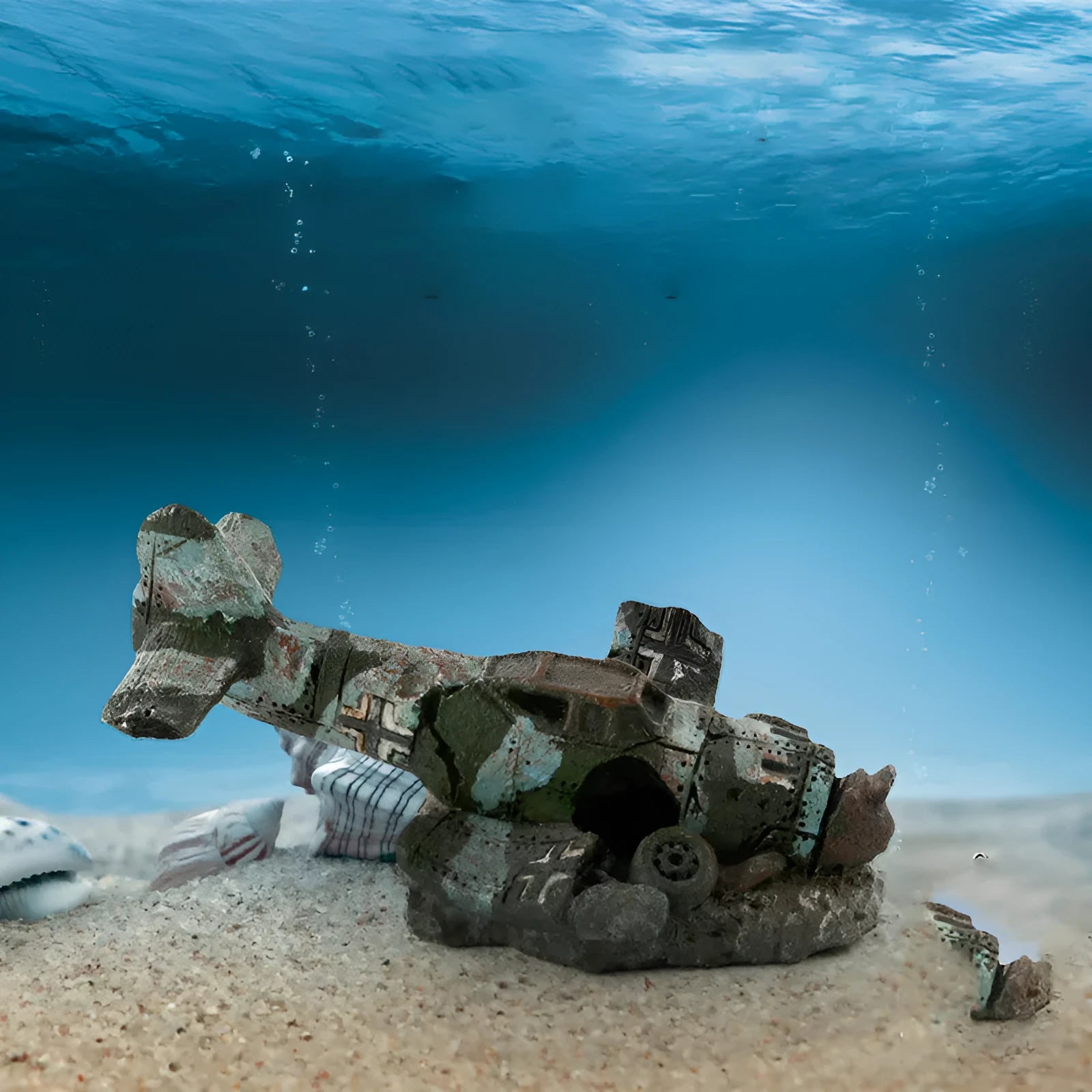 Resin simulated aircraft wreckage aquarium ornament 8cm by 4.5cm by 4.5cm on dark substrate