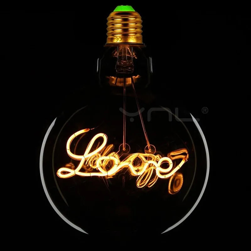 Yellow LOVE letter lamp with glass lampshade emitting warm light, 125x175mm on a tabletop