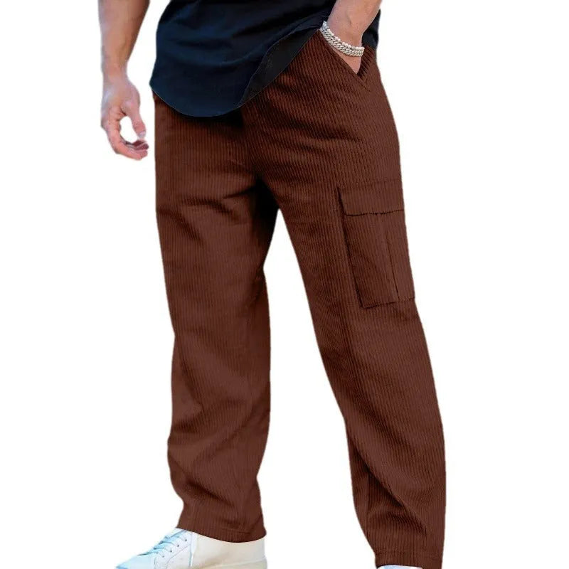 Men's navy blue corduroy cargo trousers with a drawstring waist and wide straight legs laid flat.