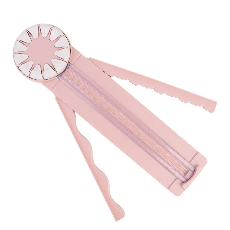 Pink 12-in-1 multifunctional paper cutting machine with dotted guide lines on its base.