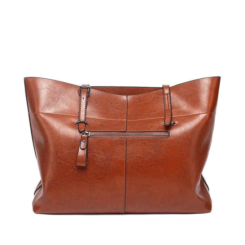 Brown waxed cowhide crossbody handbag showing front flap and adjustable strap against a neutral background.