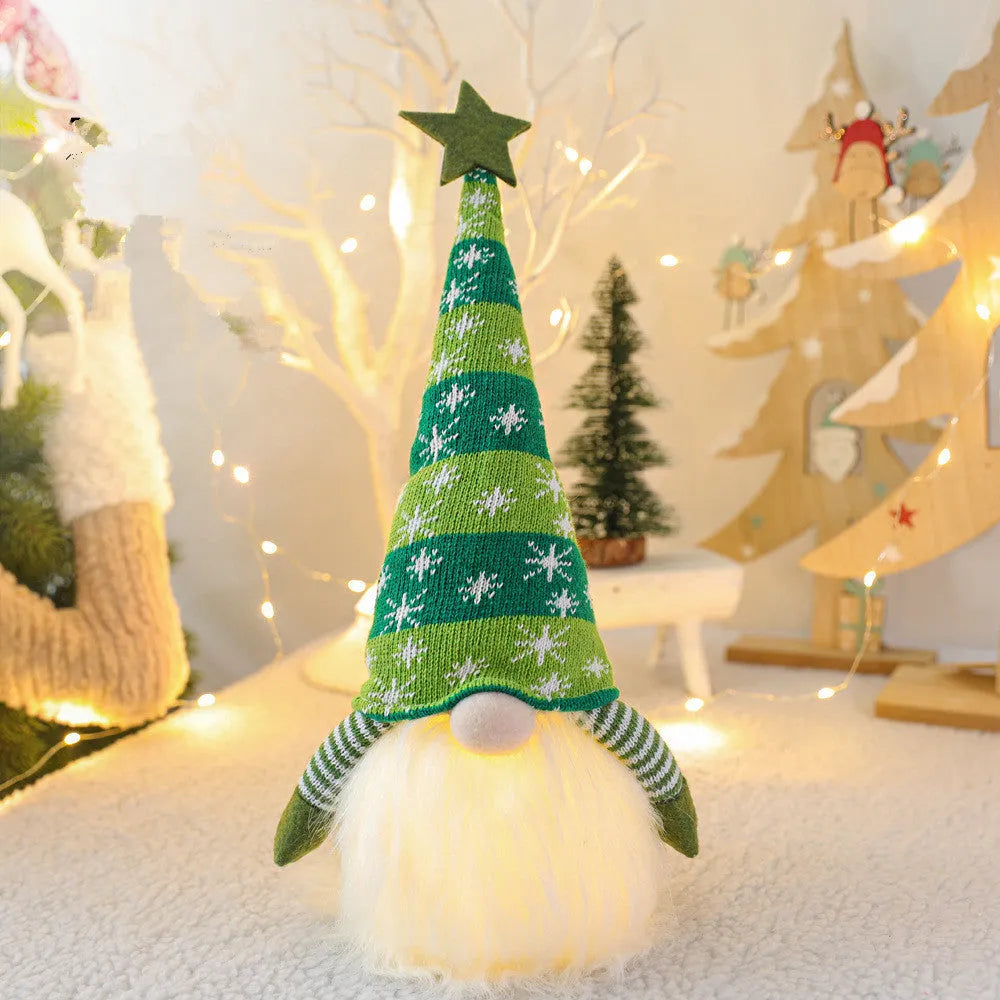 Christmas gnome faceless doll with LED light in red and green, 41 cm tall, on a shelf