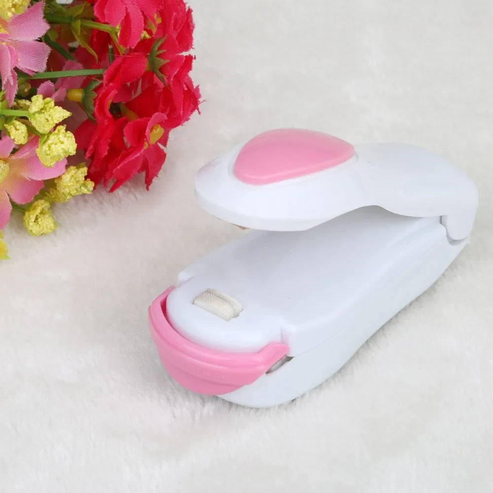 Mini hand pressure heat sealing machine in blue on white background, 10cm long ABS and metal body