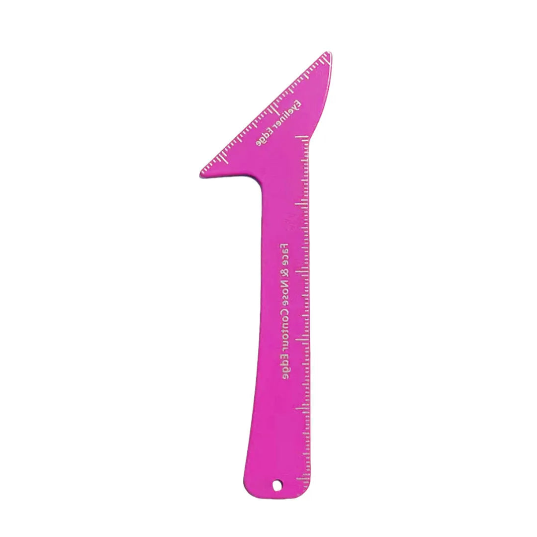Close-up of pink reusable plastic makeup stencils for eyeliner wings, eyebrow shaping, and nose contour on a table.