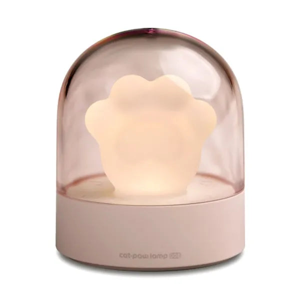 Grey cat paw shaped USB rechargeable musical night light on a wooden desk