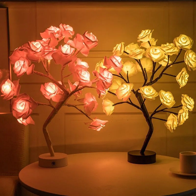 White and red rose flower LED table lamp with bonsai tree garland on a wooden table.