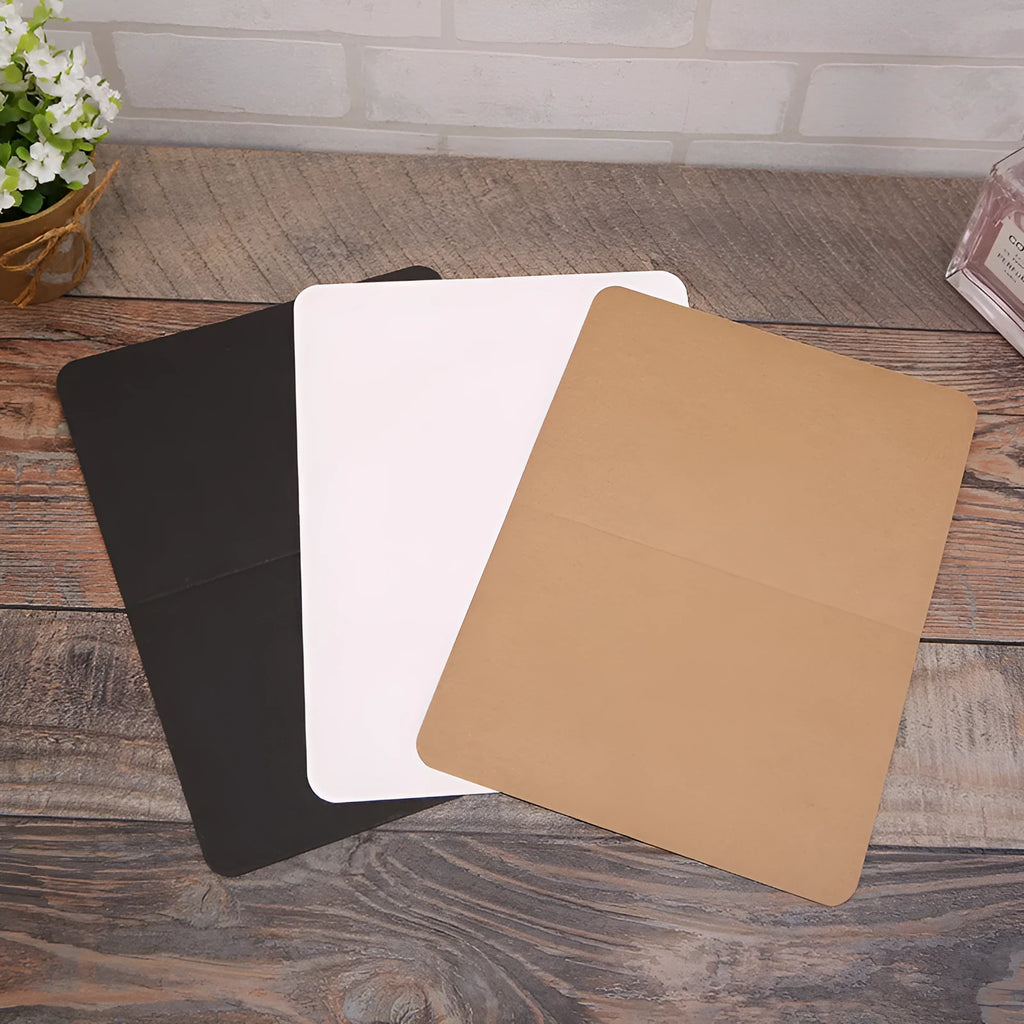 Pack of 100 blank folded kraft cards in 10x15cm size on a craft table