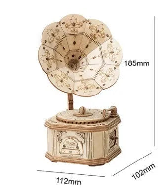 Wooden 3D puzzle model of a radio assembled from pre-cut wood pieces on a white background