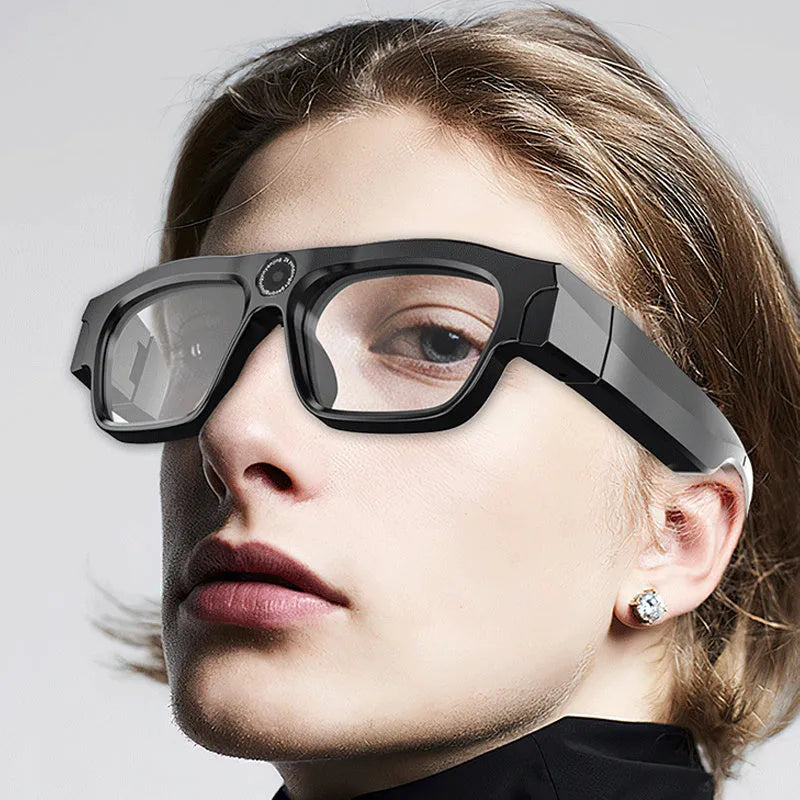 Black head-mounted smart Bluetooth glasses with a camera lens and transparent lens, shown on a model.