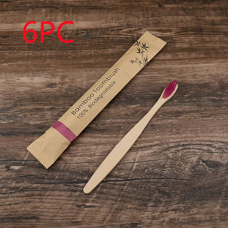 10 multi-coloured natural bamboo toothbrushes with soft charcoal bristles arranged on a white background