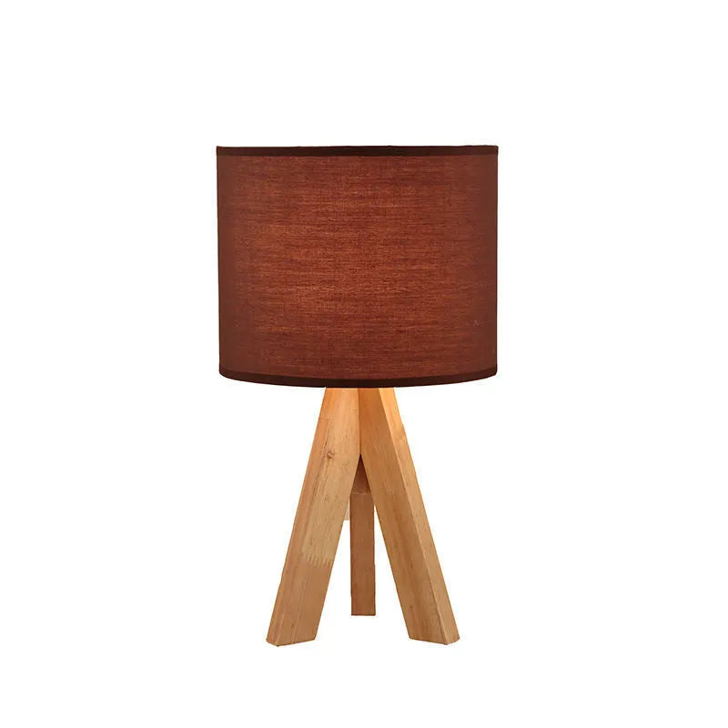 Japanese style solid wood table lamp with fabric lampshade in brown trumpet colour on bedside table