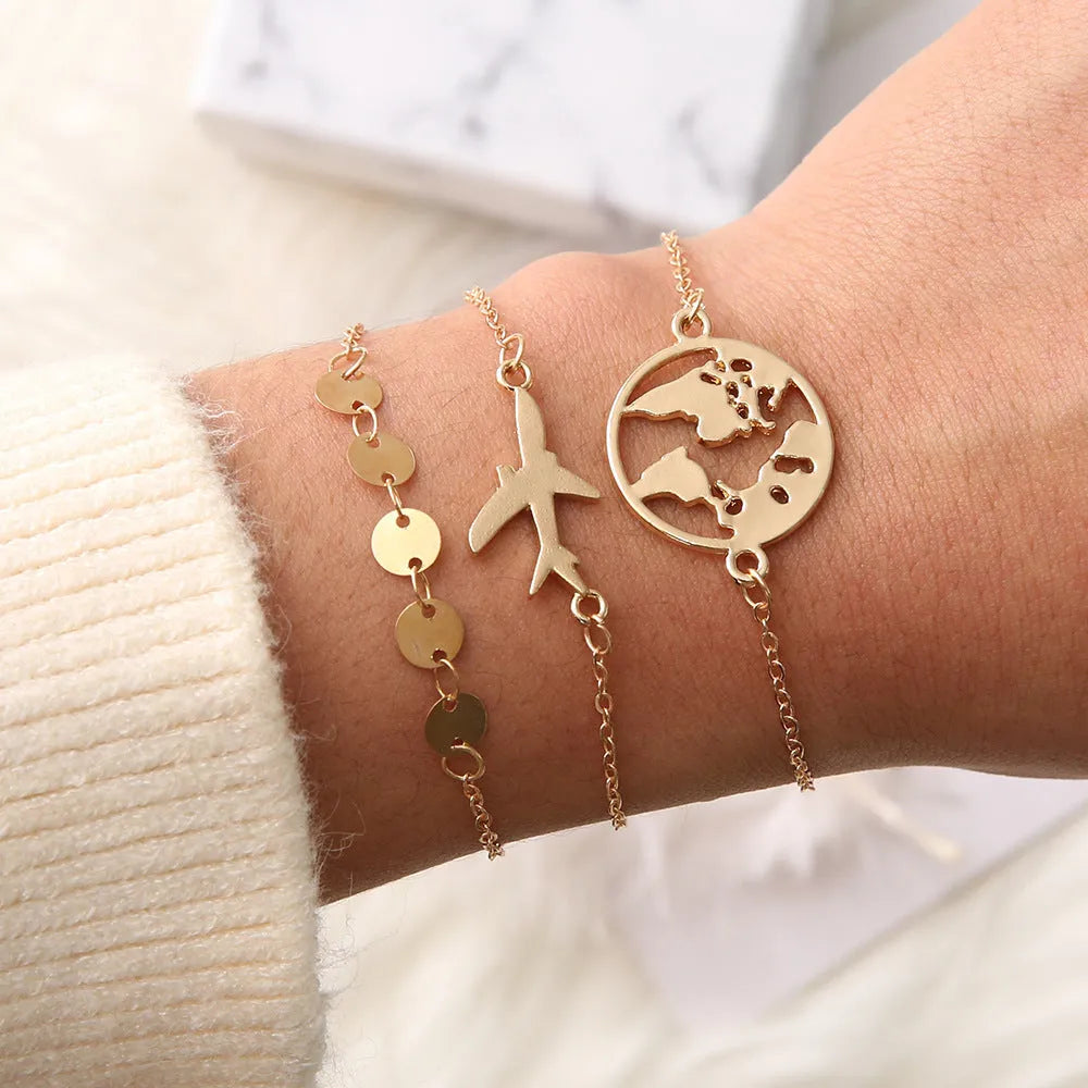 Three women's charm bracelets with heart-shaped aircraft map pendants in alloy with electroplated finish