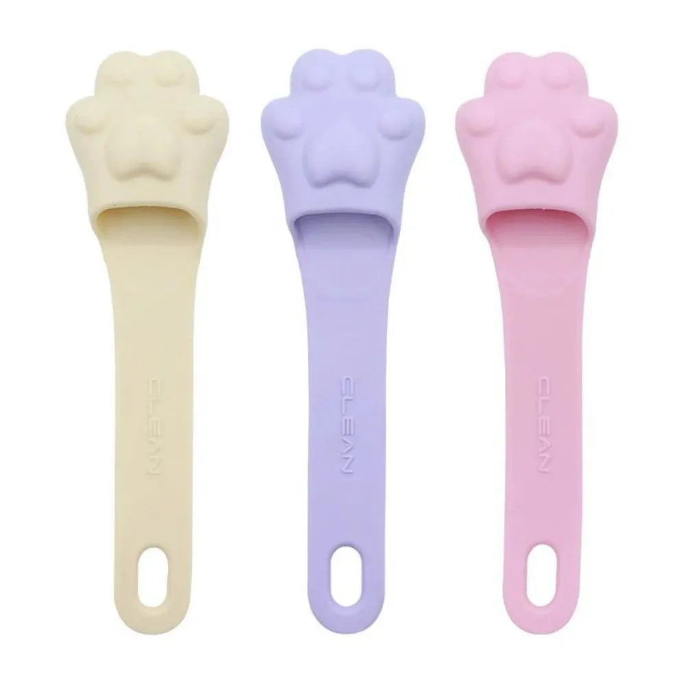 Pink silicone finger cover toothbrush for pets on a white background
