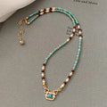 Natural turquoise pearl necklace with gold plated copper chain and matching bracelet on display