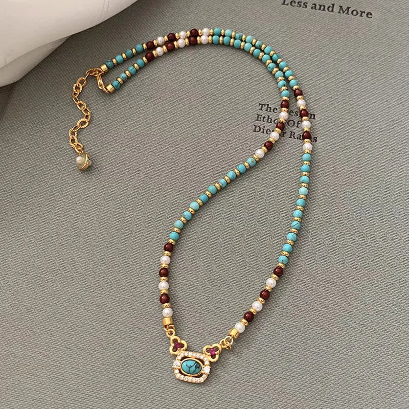 Natural turquoise pearl necklace with gold plated copper chain and matching bracelet on display