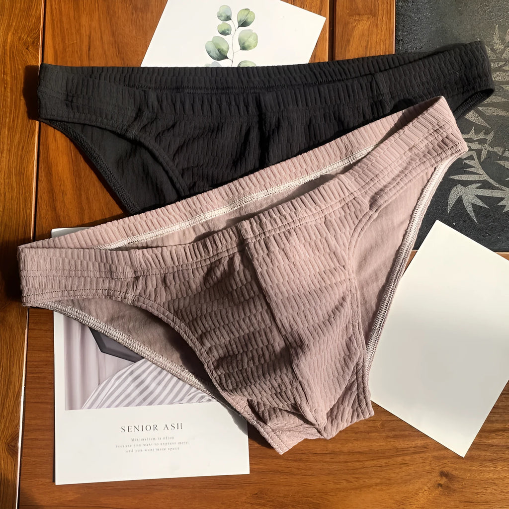 Men's triangle underwear briefs in solid colours showing cotton fabric texture and mid waist design