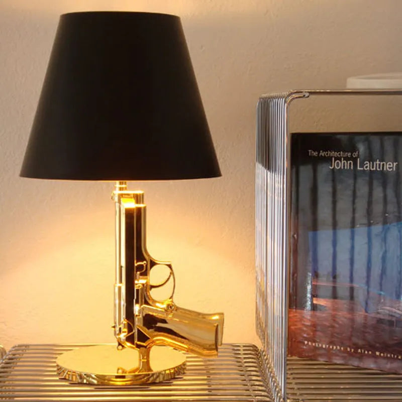 Creative resin desk lamp with plated gold pistol shape on a desk, 235x425mm, Nordic style