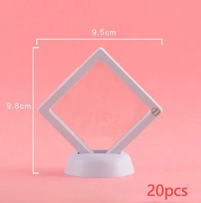 3D floating display case holding a coin suspended between transparent membrane sheets, black frame