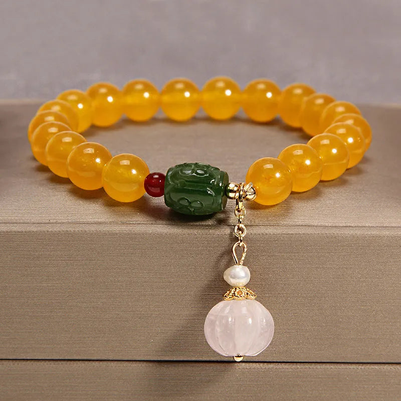 Khaki coloured crystal bracelet for women with an adjustable gold silk cord fastening.