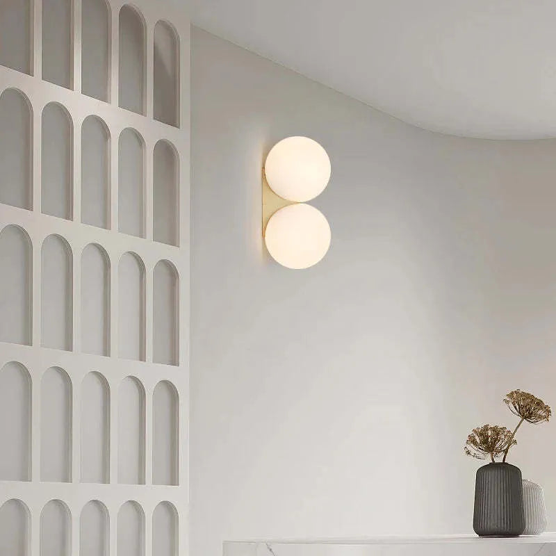 Simple glass ball wall lamp with gold finish and iron frame for bedroom bedside