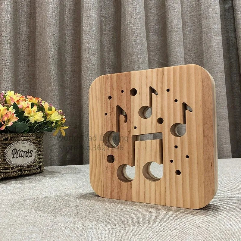 Square pine wood USB LED lamp with warm white light on a wooden desk next to a laptop.