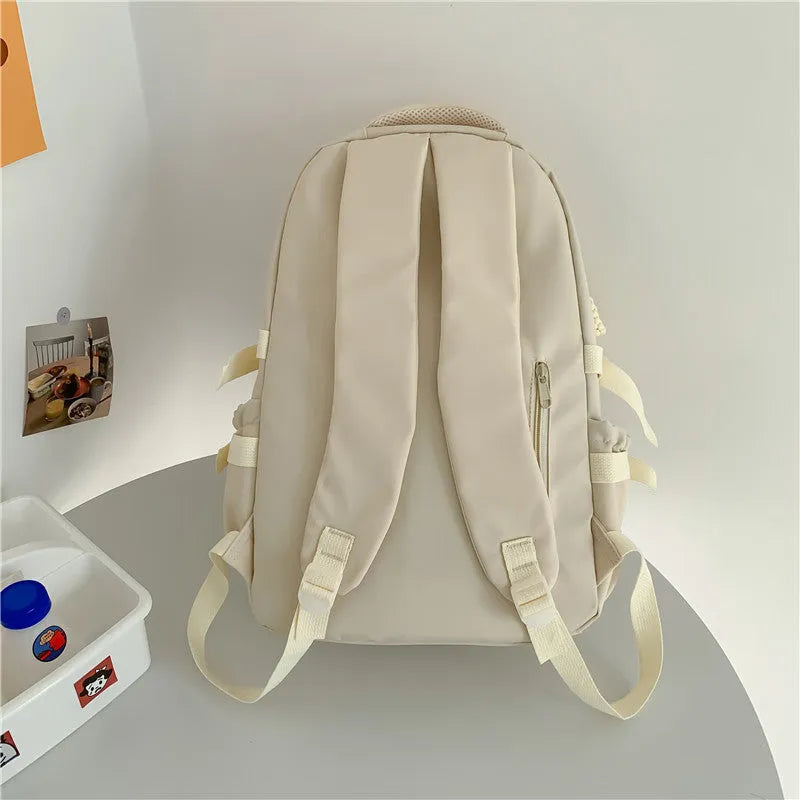 Korean-style lightweight nylon waterproof school backpack in beige with curved shoulder strap