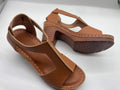 Plus size women's beige peep toe wedge sandals with a buckle strap and low heel.