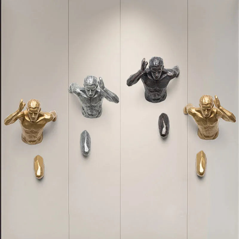 Resin character wall hanging decoration in metallic finish on a plain wall
