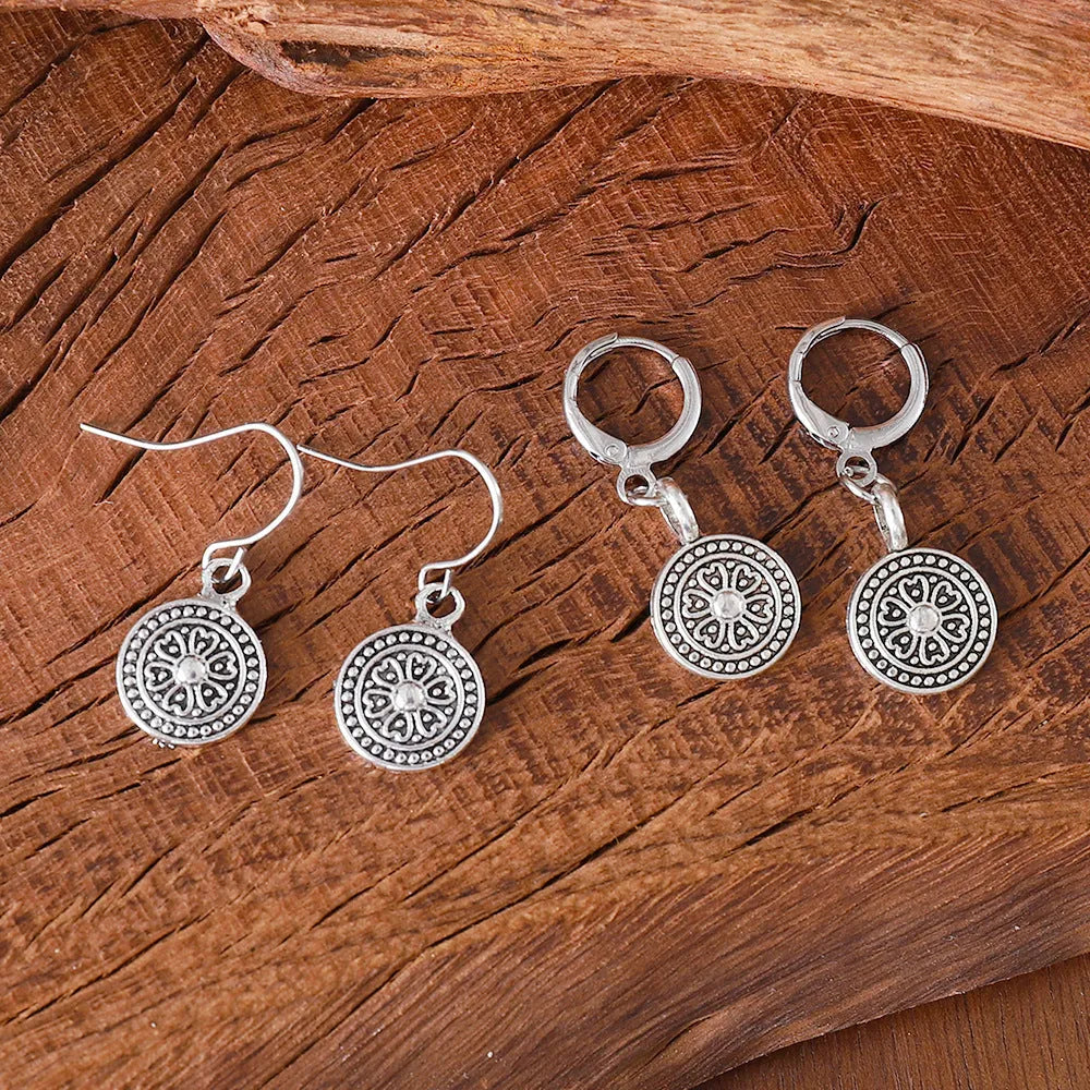 A pair of geometric Bohemian-style retro earrings with a distressed round ethnic print on zinc alloy.