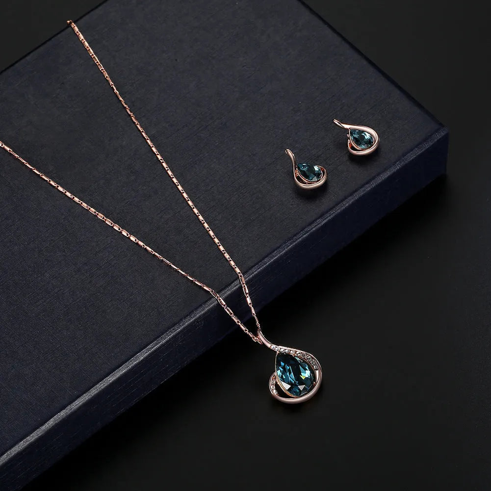 Rose gold alloy necklace and earrings bridal set with diamond crystal pendant and artificial gem inlay