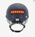 Cycling helmet with integrated red LED tail light on the back, shown in sizes M and L.