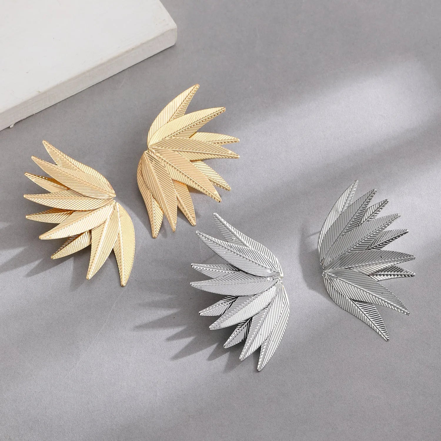 Gold and white alloy patch earrings with leaves shape design