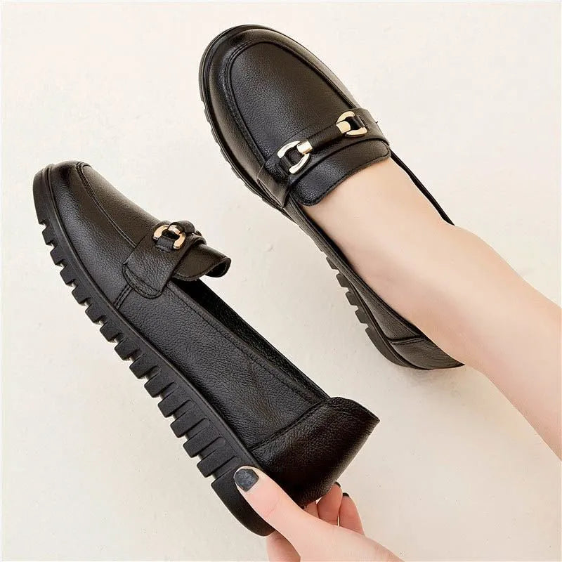 Black soft leather women's loafers with round toe and low flat heel on a rubber sole.